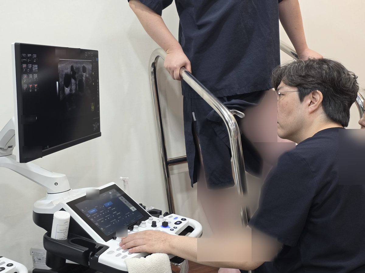 의료진이 초음파 장비 화면을 보며 환자의 다리 부위를 검사하는 장면